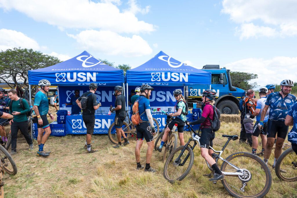Sani2c, Even after 21 years, Farmer Glen and his team are constantly refining the experience. “We’re always tweaking the route. It might be small things, but they make a big difference,” he explains. This year, there’s a new farm section on Day One, while Day Three will see a fresh attempt at making the famous Scottburgh lagoon crossing more dramatic.